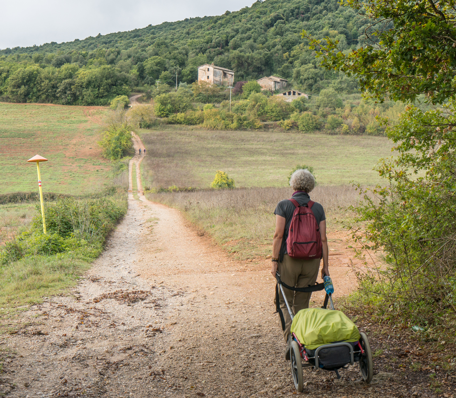 A pilgrim on the Via Francigena north of the Castello della Chicciola (Italy) | Photo by Mike Hudak